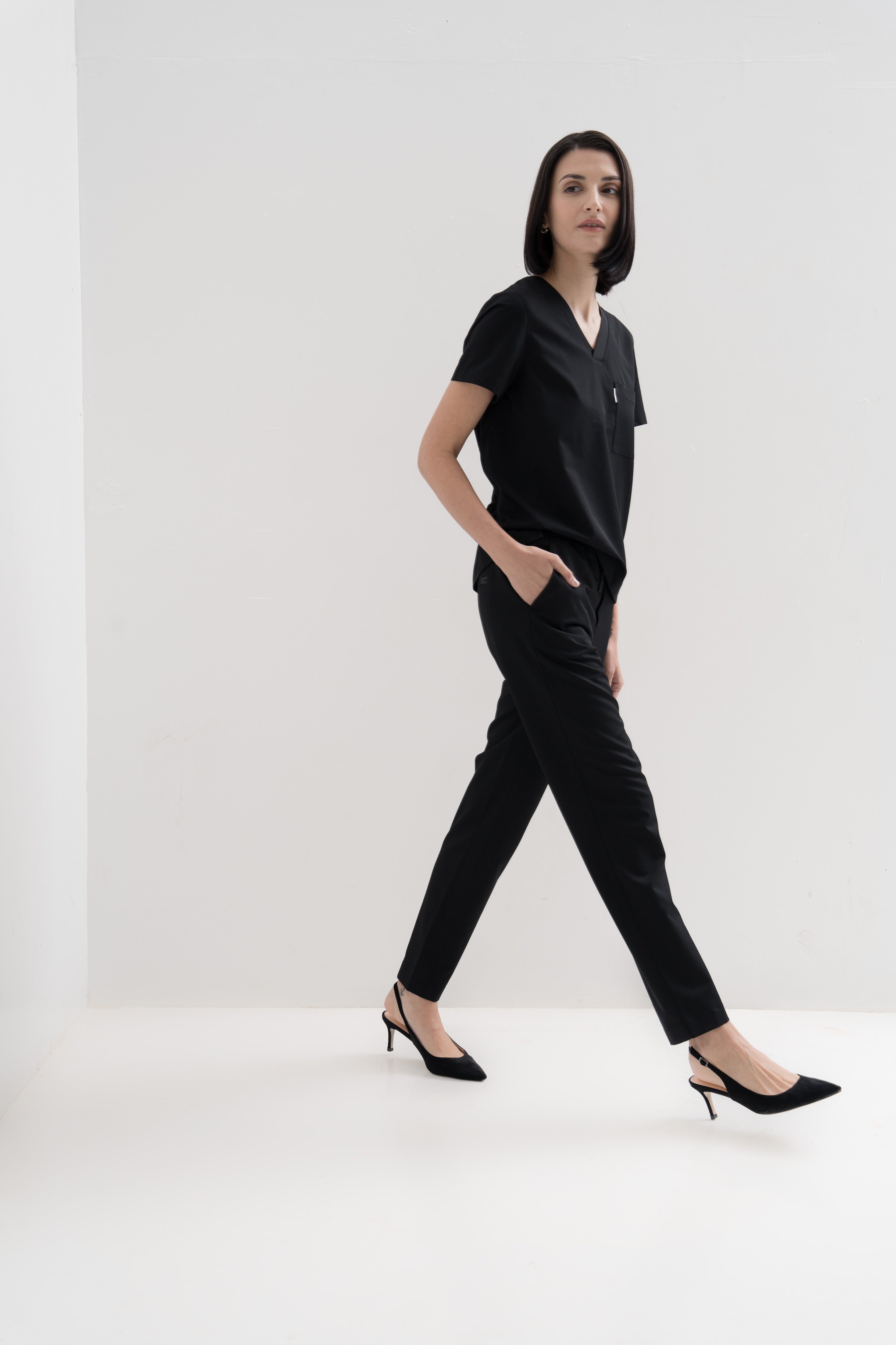 Women's scrub pant in black, full body view.