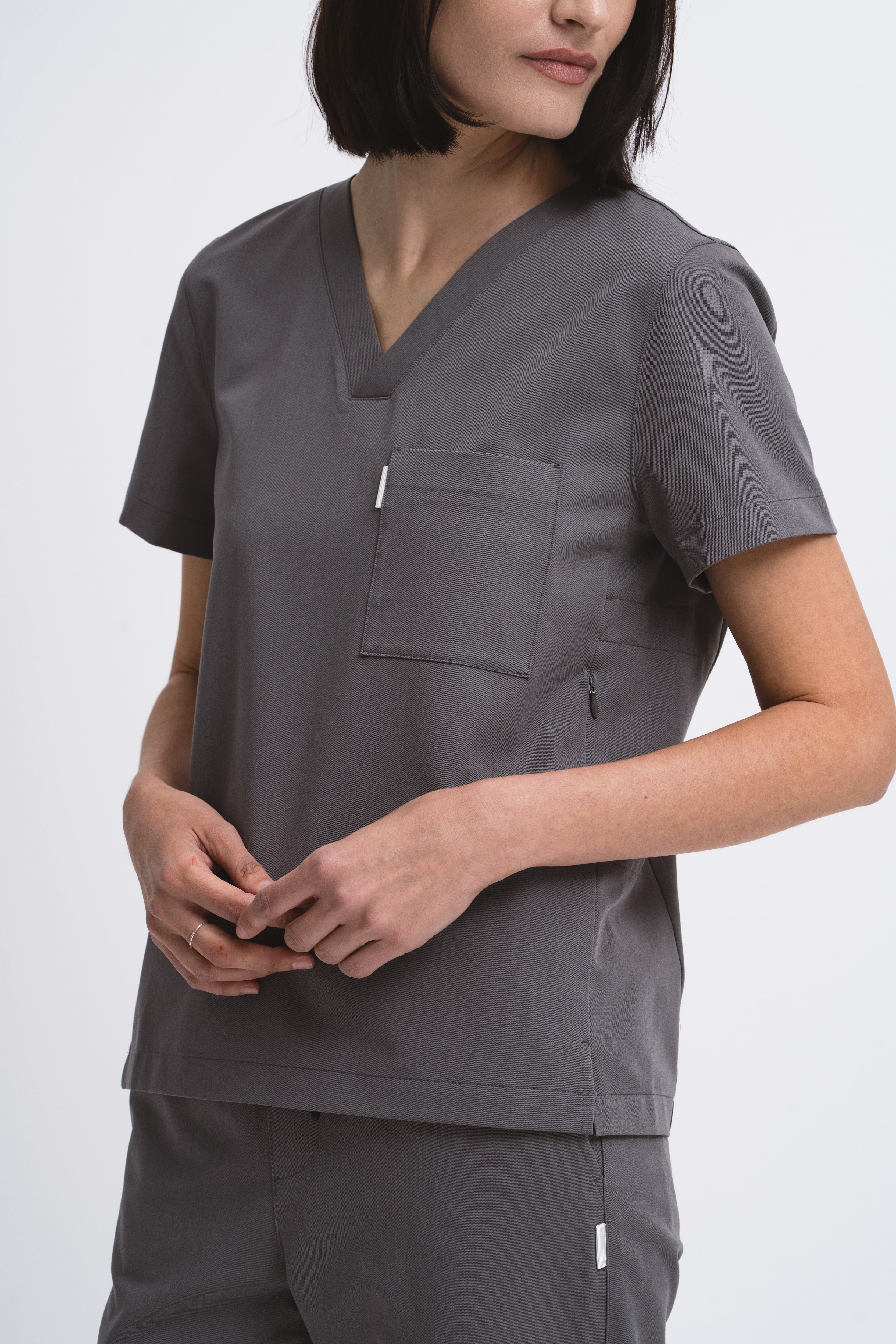 Close-up detail of the women's V-neck scrub top in grey.