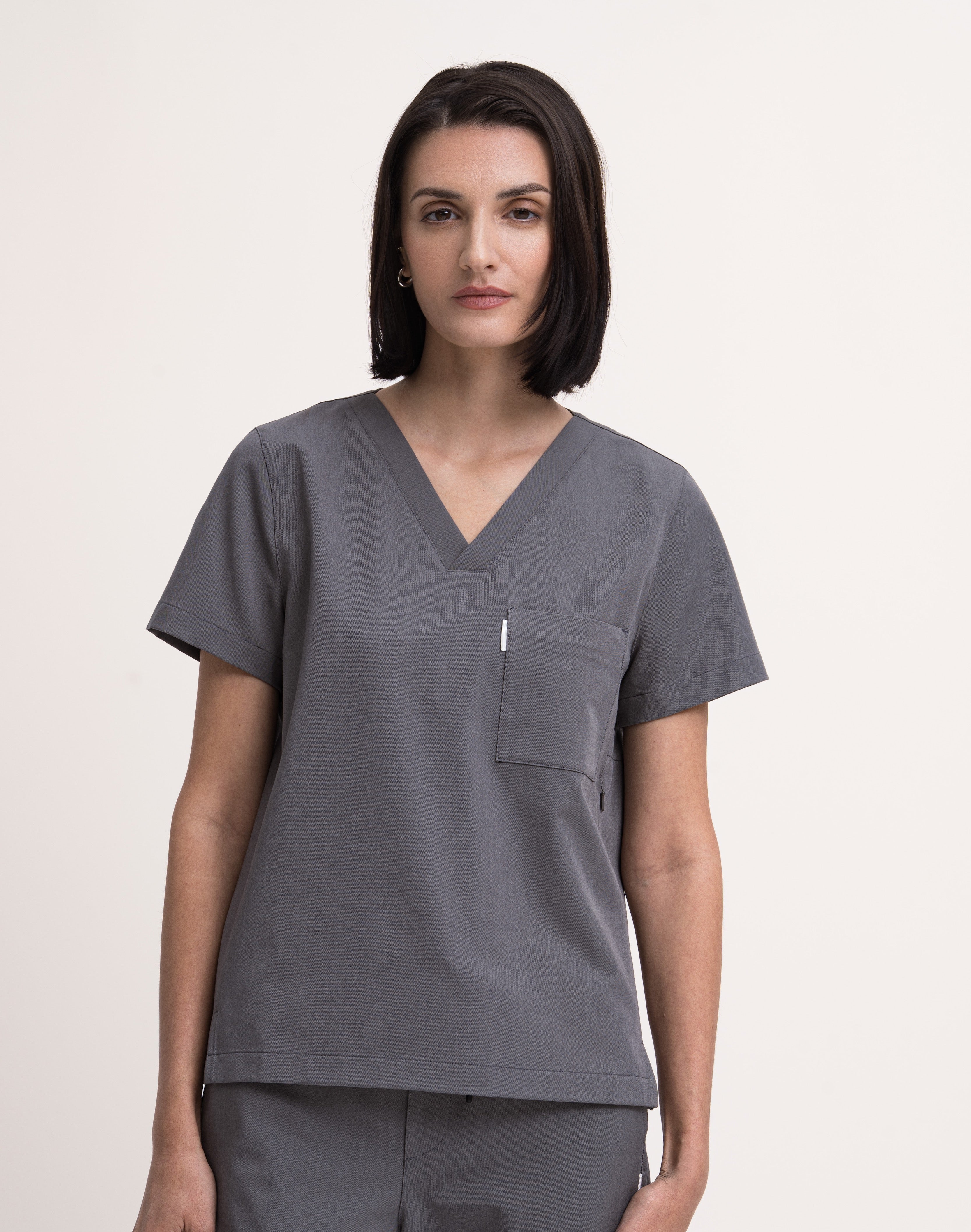 Women's V-neck scrub top in grey, front view, quarter body.