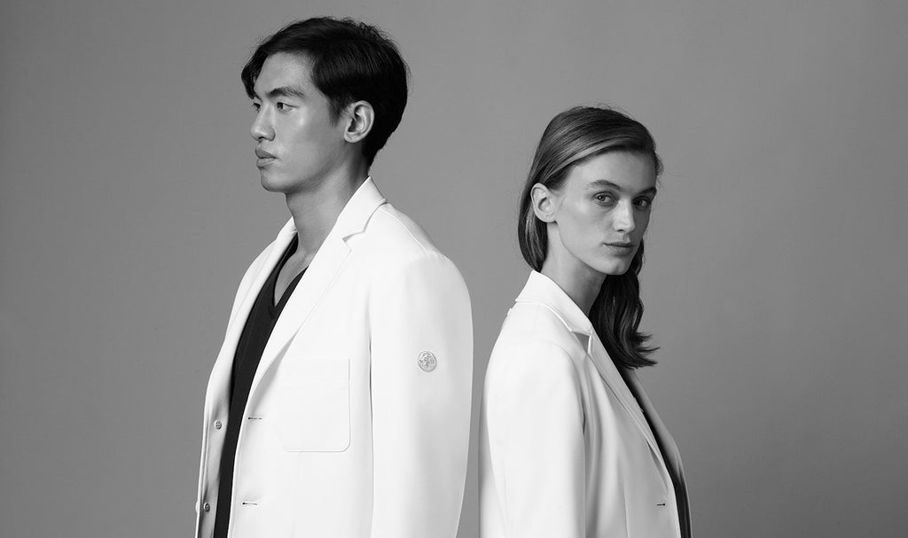 A woman and a man wearing a white lab coat made by L'Atelier Forte