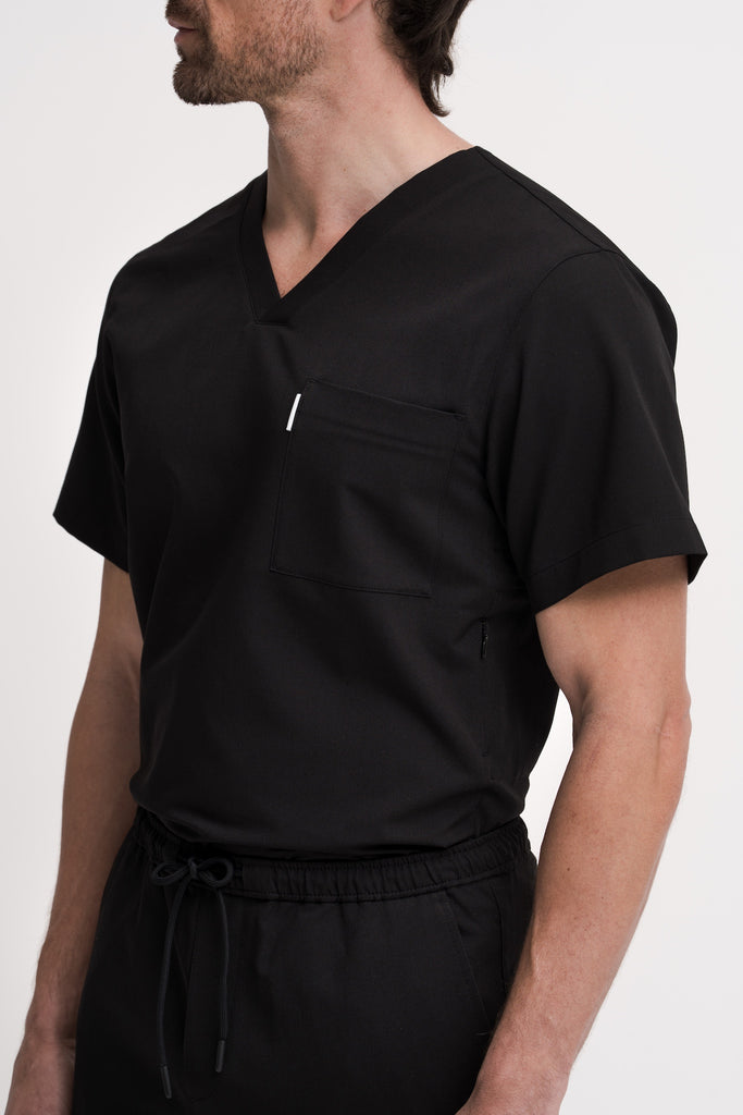 Close-up detail of Men’s Core V-Neck Scrub Top in navy – featuring premium fabric, discreet pockets, and modern craftsmanship
