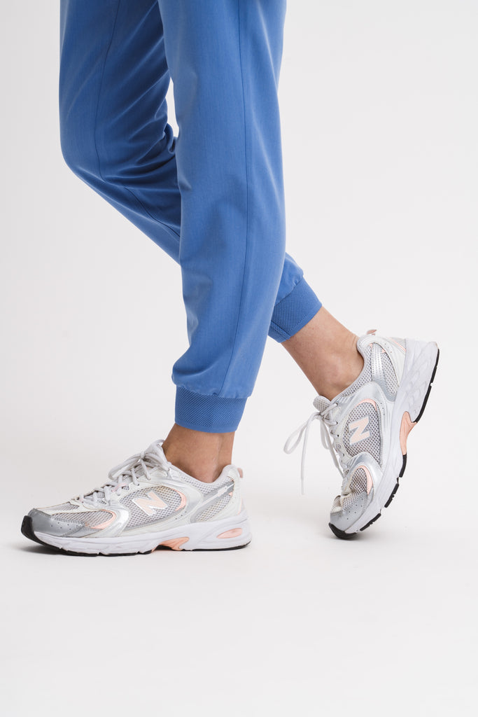Close-up detail of the ribbed ankle cuff on the women’s jogger scrub pant in Sailor Blue.