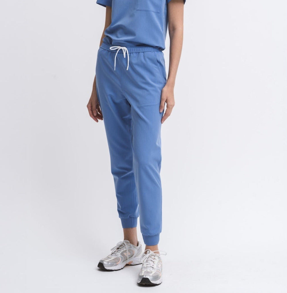 Women's jogger medical scrub pant in Sailor Blue, front view, half body.

