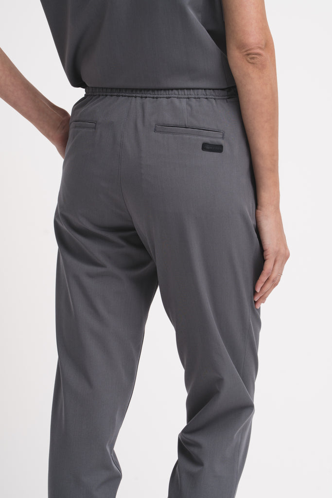 Women's scrub pant in grey, back view, half body.