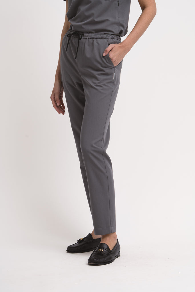 Women's scrub pant in grey, front view, half body.