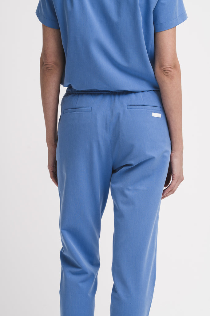 Women's scrub pant in Sailor Blue, back view, half body.