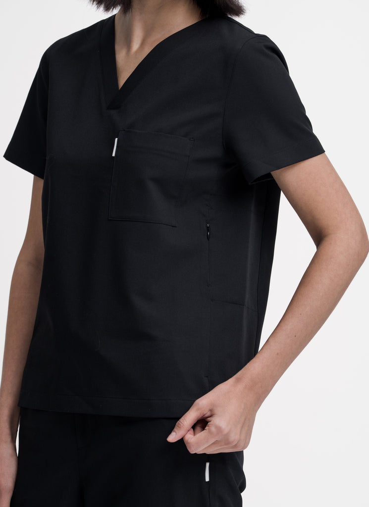 Close-up detail of the women's V-neck scrub top in black.