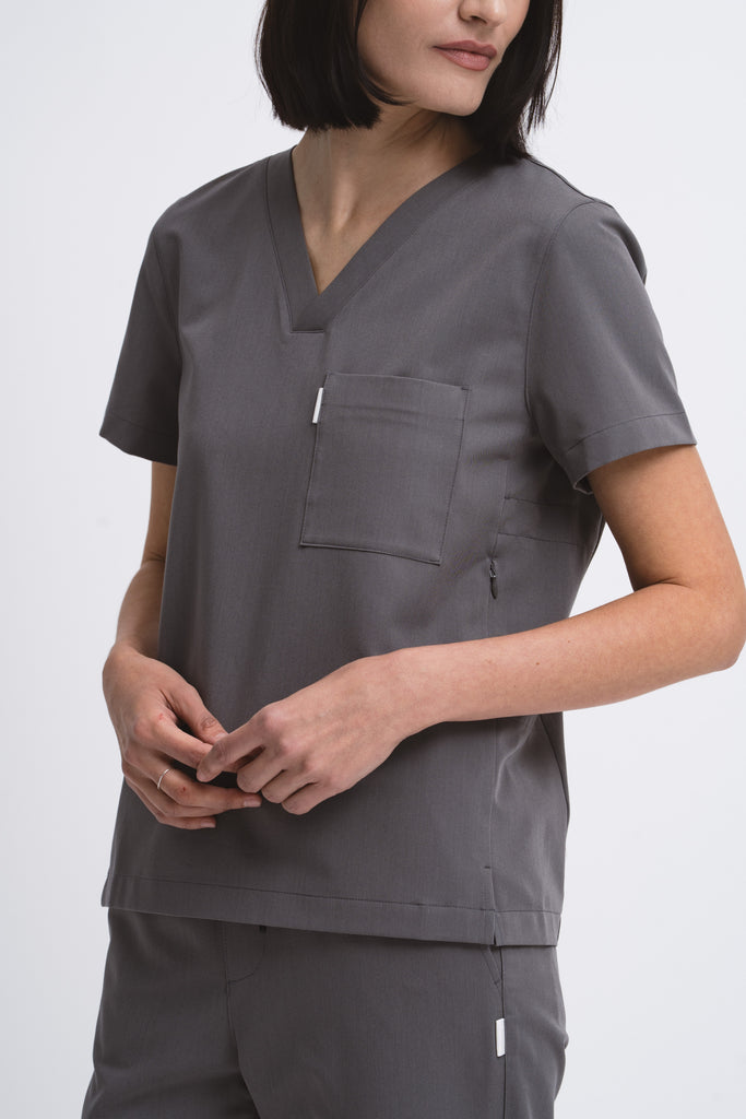 Close-up detail of the women's V-neck scrub top in grey.