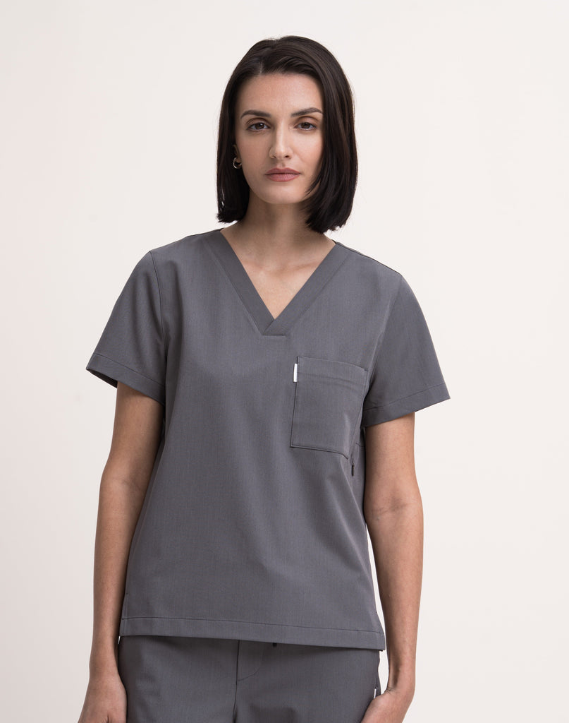 Women's V-neck scrub top in grey, front view, quarter body.