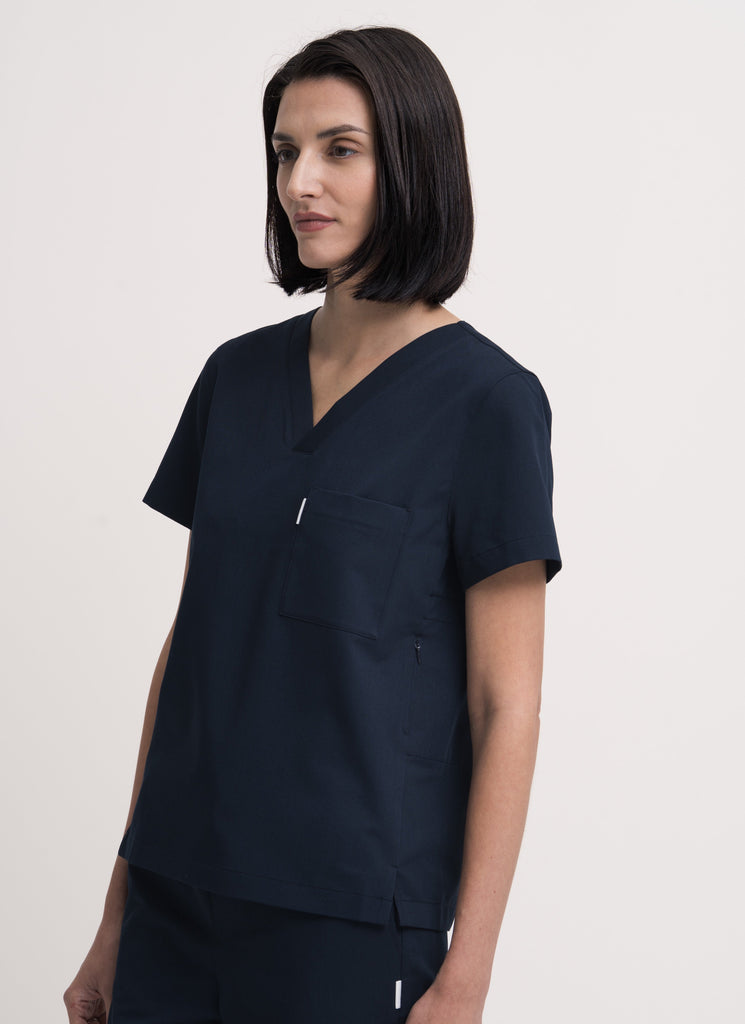 Close-up detail of the women's V-neck scrub top in navy.