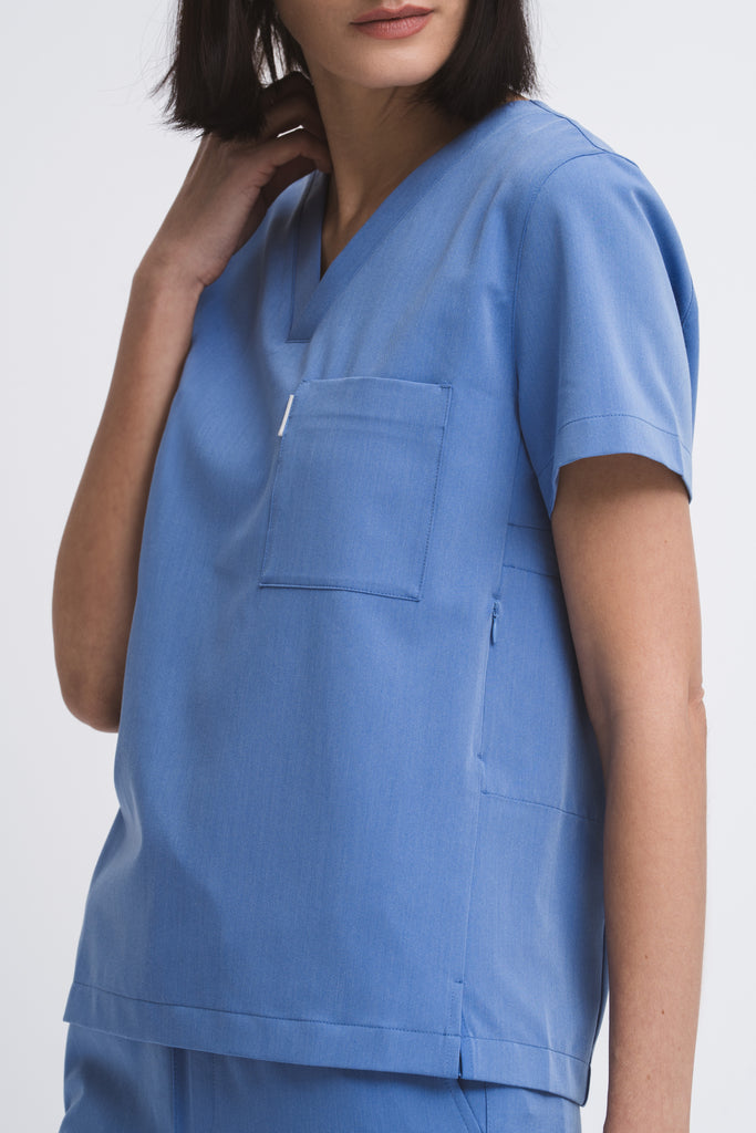 Close-up detail of the women's V-neck scrub top in Sailor Blue.